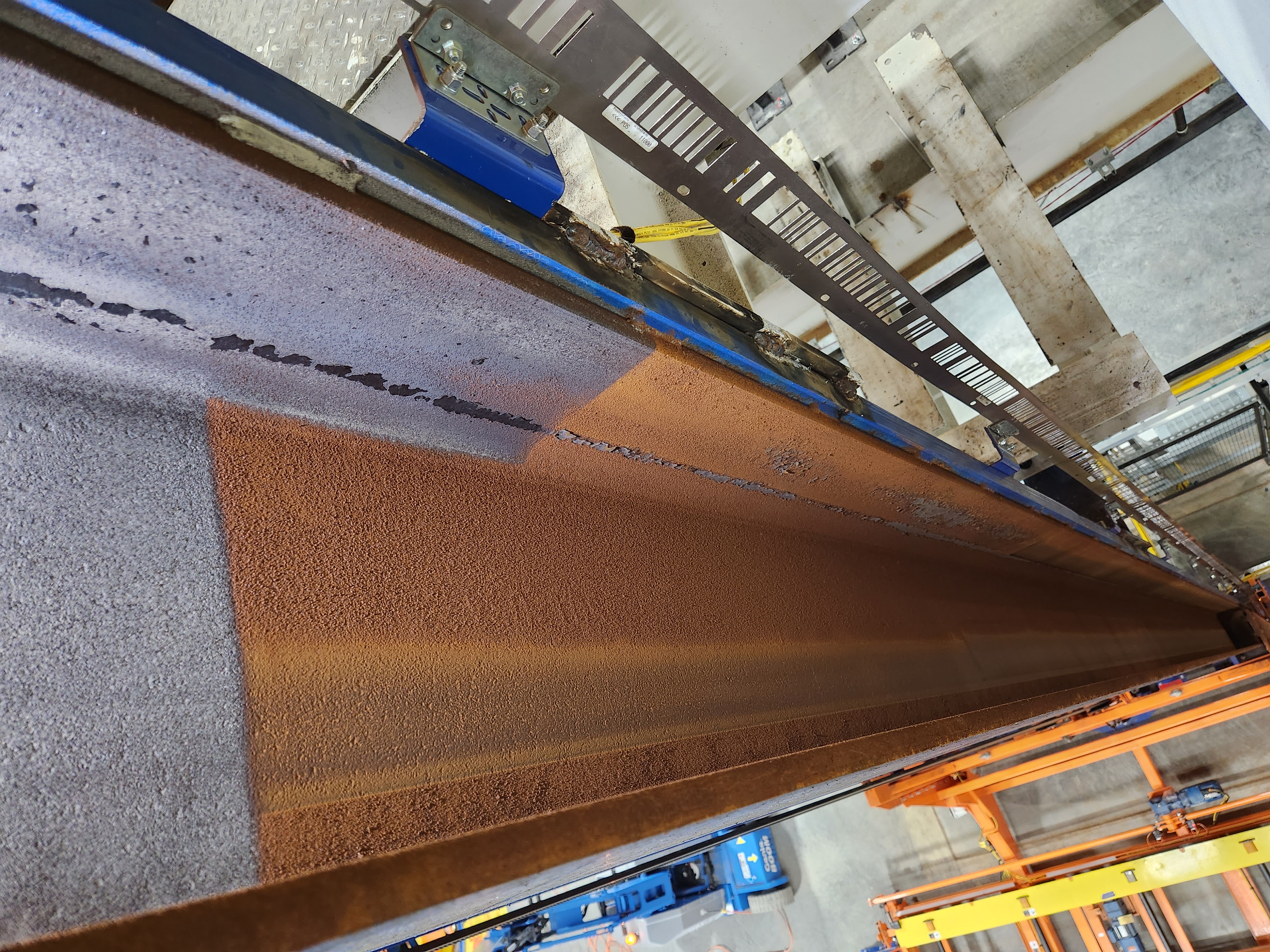 I-Beam rust removal in warehouse.